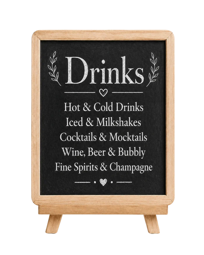 Chalkboard menu listing hot and cold drinks, iced and milkshakes, cocktails and mocktails, wine, beer and bubbly, and fine spirits and champagne